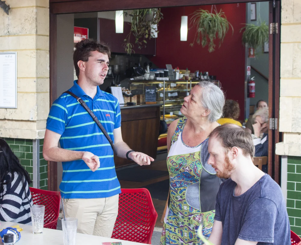 Friends talking at a cafe meet up