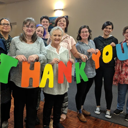 Happy people holding thank you sign