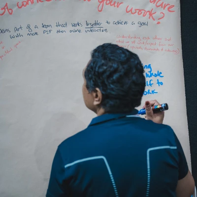 Man writing in a workshop