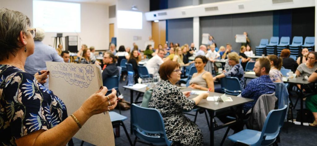 Conference attendees around tables