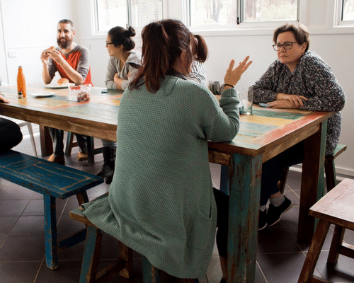 Friends talking around a table